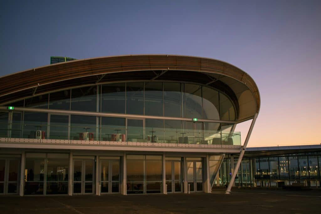 Modern airport hotel exterior with glass facade, similar to Hilton Munich Airport